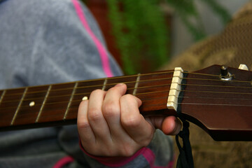 Child plying guitar.