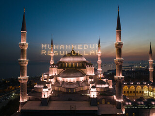 Fototapeta na wymiar Blue Mosque (Sultanahmet Camii) Illuminated Letters Between Ramadan Month Minarets (Mahya) Drone Photo, Sultanahmet Square Fatih, Istanbul Turkey