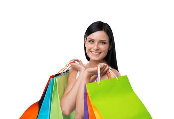 A happy woman holding colorful shopping bags, isolated on a white background, consumerism and shopping concept