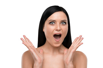 Surprised woman with dark hair expressing excitement, photographed against a white background....