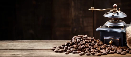 Fotobehang Coffee beans grinder on wooden table © Ilgun
