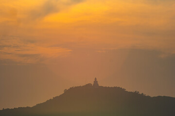 scenery yellow sky glare of sun above Phuket big Buddha.Phuket Big Buddha is one of the island most...