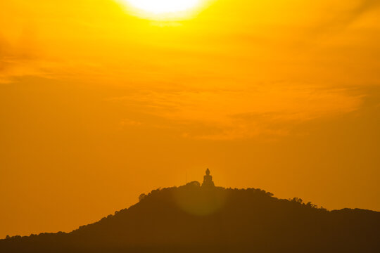scenery yellow sky glare of sun above Phuket big Buddha.Phuket Big Buddha is one of the island most important and revered landmarks on the island..image for travel and culture concept..