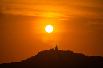 The sun circles in the red sky above Phuket  Big Buddha..Amazing Phuket big Buddha in circle of the...