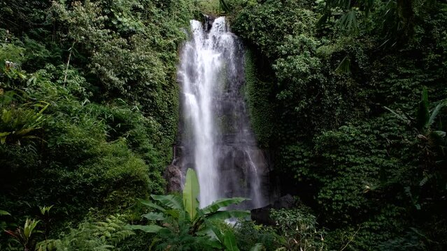 Tripod footage of Golden Valley waterfall on sunny day. Munduk, Bali, Indonesia.
