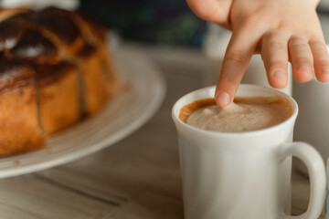 Person Reaching for Cup of Coffee