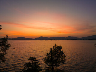 Orange sky at sunset above Khao Khad viewpoint Phuket. Beautiful The glare of the sun shone through...