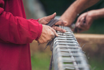 Construction Men hands bending cutting steel wire fences bar reinforcement of concrete work. Worker...