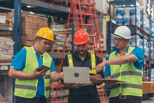 Warehouse management multiracial team partner engineer man work together checklist stock control. Warehouse worker teamwork diversity men using laptop logistics counting products store inventory.