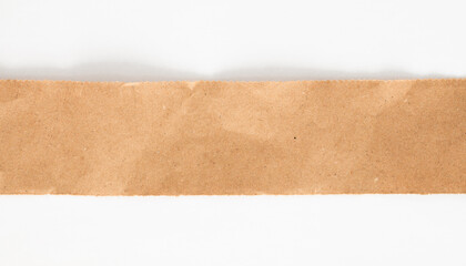 A close-up of a strip of brown paper centered against a white backdrop.