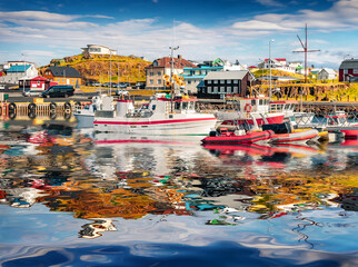 Colorful fishing boats in Stykkisholmur port reflected in the calm waters of North Atlantic Ocean....