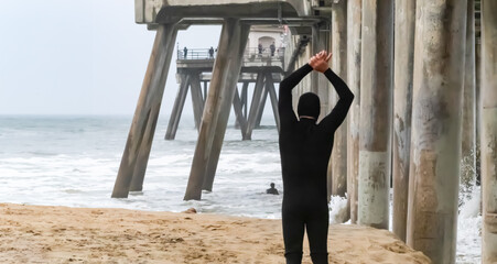 Unknown Surfer Stretches Near Huntington Beach Pier, on Misty, Stormy, November Afternoon,...