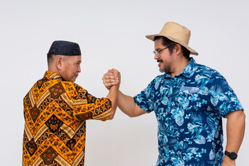 An Indonesian man in batik and kopiah forms a pact with a tourist in a Hawaiian shirt, symbolizing...