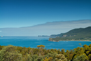 Beautiful coastal scenery in Tasmania: Cliffs and turquoise waters merge, framed by rugged...