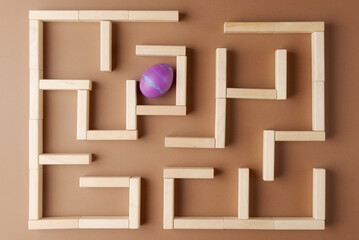 Decorative Easter Egg in Wooden Maze. Easer tradition concept. Egg hunt or search