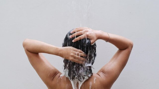 Beautiful woman's hand She was washing her hair and nourishing her scalp. Shampoo and conditioner