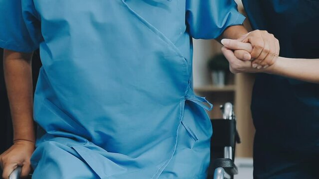 Asian female physiotherapist helping senior older woman stretching hamstring, Rehabilitation physiotherapy, elderly. Causes knee pain, swelling, redness, stiffness in knee, clunking noise in knee.