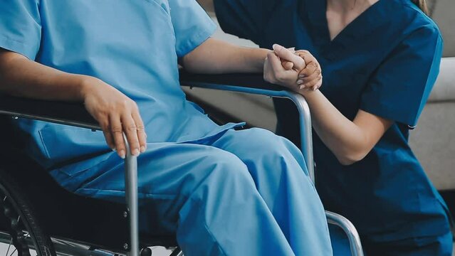 Asian female physiotherapist helping senior older woman stretching hamstring, Rehabilitation physiotherapy, elderly. Causes knee pain, swelling, redness, stiffness in knee, clunking noise in knee.