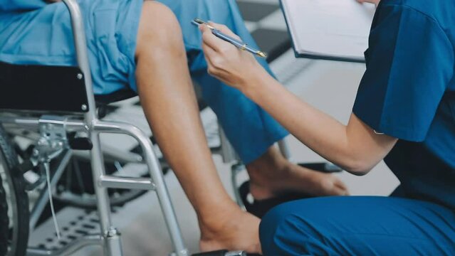 Asian female physiotherapist helping senior older woman stretching hamstring, Rehabilitation physiotherapy, elderly. Causes knee pain, swelling, redness, stiffness in knee, clunking noise in knee.