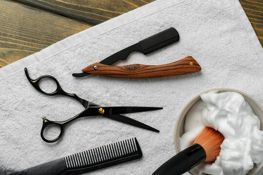 Hairdressing barber tools on wooden background close up