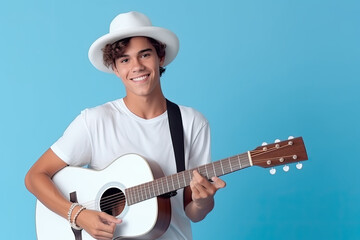 Obraz premium Teenager boy playing the guitar on blue background.