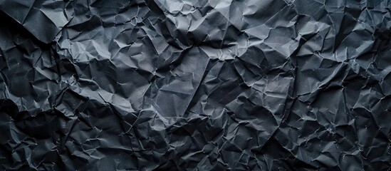Dark backdrop with texture of crumpled paper.
