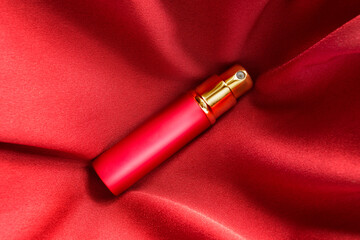 Perfume on red silk