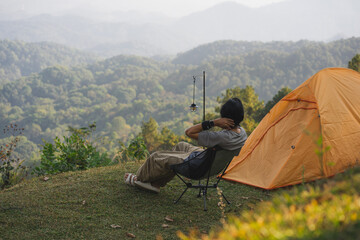 landscape and travel concept with solo freelancer man relax and see sunset and twilight sky with layer of mountain