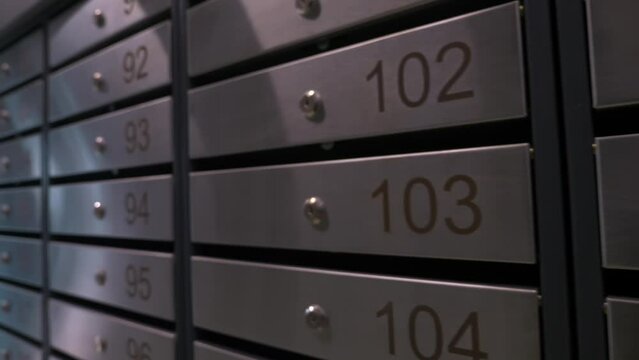 Metal mailboxes with apartment numbers in a multi-story building