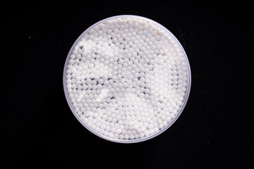 Close-up of a box of unopened cotton swabs on a black background