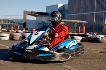 Kart pilot ready to start championship in outdoor go-karting circuit