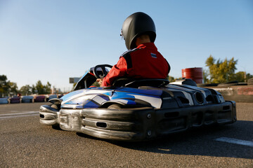Back view shot of competitive racer driving go-cart sports track - obrazy, fototapety, plakaty