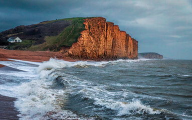 The dramatic sandstone east cliff and Jurassic coast from West Bay on the Dorset coast south west...