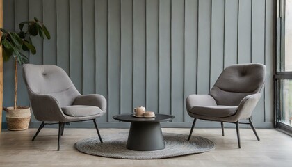 Two grey lounge chairs and round coffee table against grey paneling wall. Minimalist home interior design of modern living room