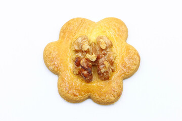 A flower-shaped cookie with a nut on top. Healthy food