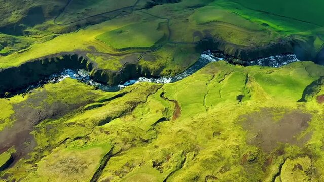 A 4K drone, aerial cinematic shots of beautiful green landscape with the zigzag formation of the river in between.