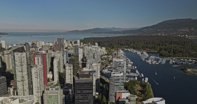 Vancouver BC Canada Aerial v98 establishing shot drone flyover downtown capturing bayshore cityscape of Coal Harbour, bustling marina and Stanley Park views - Shot with Mavic 3 Pro Cine - July 2023