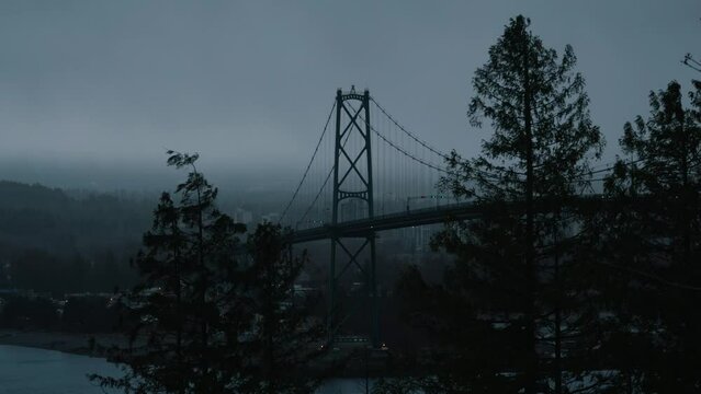 view of Lions Gate Bridge in Vancouver from Prospect point lookout on a rainy day and moody atmosphere during winter, british columbia, canada