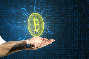Close up of male hands holding creative bitcoin circuit hologram on tech blue background. Cyber...