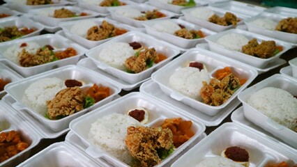 Rows of packages of rice box, crispy chicken and seasoned eggs