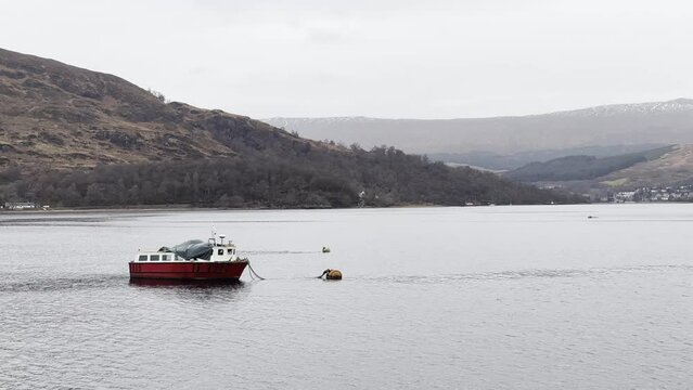 Fishing boat floating gently anchored on Loch Eil in Fort William, Scotland