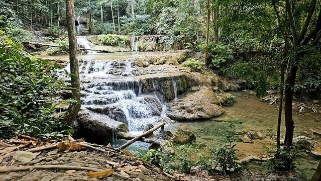 Tranquil cascade at Erawan National Park, Kanchanaburi with lush greenery and serene water flow