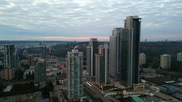 Aerial city view of residential buildings and roads. Cloudy sunset, evening sky. Burnaby, British Columbia, Canada.