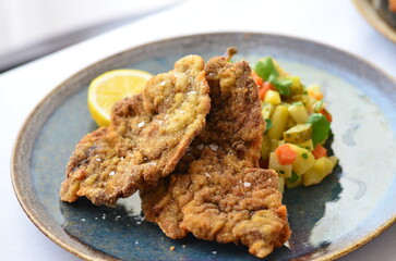 French traditional cuisine crispy, creamy chicken cordon bleu isolated on white background