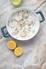 Serving pan with new england clam chowder on a light-grey granite background, vertical shot with space, above view
