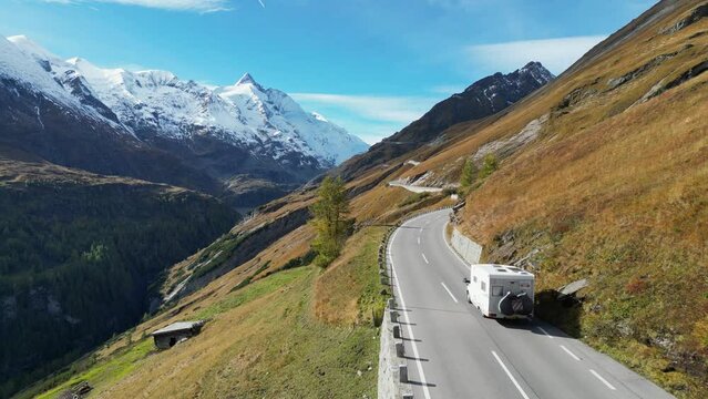 Camper drive Grossglockner High Alpine Road in Austria Alps - Aerial 4k