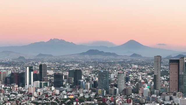 Drone shot of mexico city with volcanoes in sight