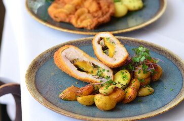 Wiener schnitzel with salad on a restaurant table.
