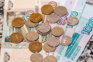 Russian ruble Russian rubles in coins on banknotes background.