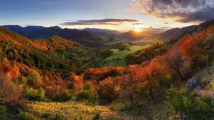 Mountains at sunset in Slovakia. Landscape with mountain hills orange trees and grass in fall, colorful sky with golden sunbeams. Panorama - 762134346